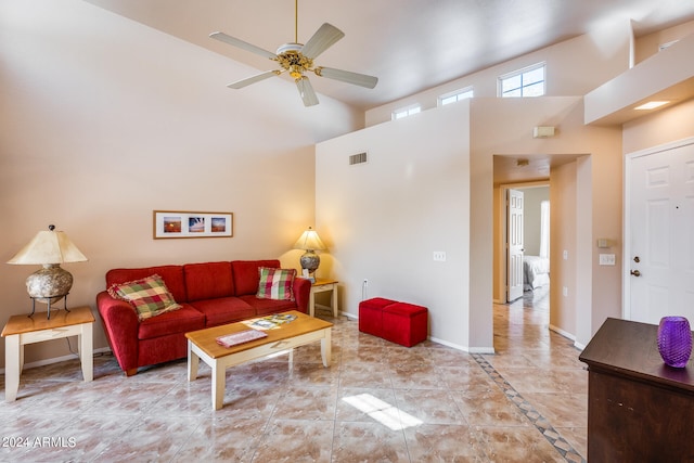 living room featuring a high ceiling and ceiling fan