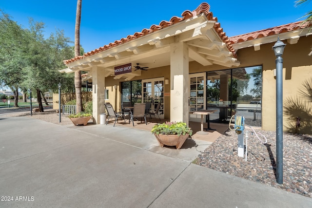 exterior space with ceiling fan