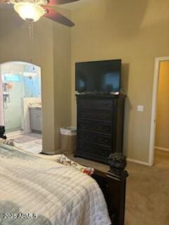 bedroom featuring ceiling fan, carpet floors, and ensuite bath