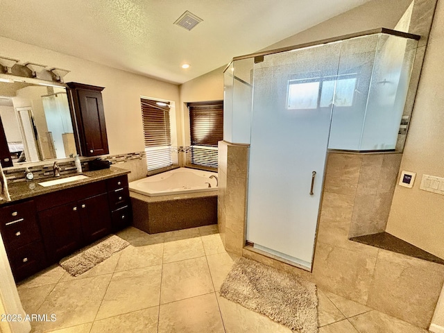 bathroom with vanity, vaulted ceiling, tile patterned floors, and independent shower and bath