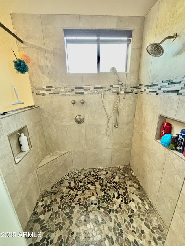 bathroom with tiled shower