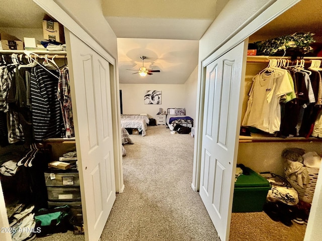 spacious closet with light carpet and ceiling fan