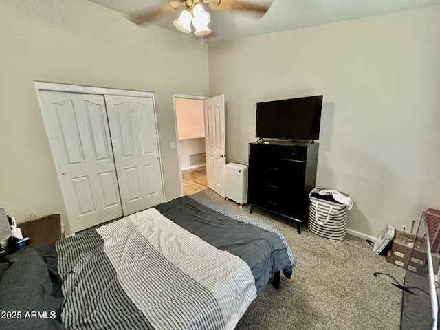 carpeted bedroom featuring ceiling fan and a closet