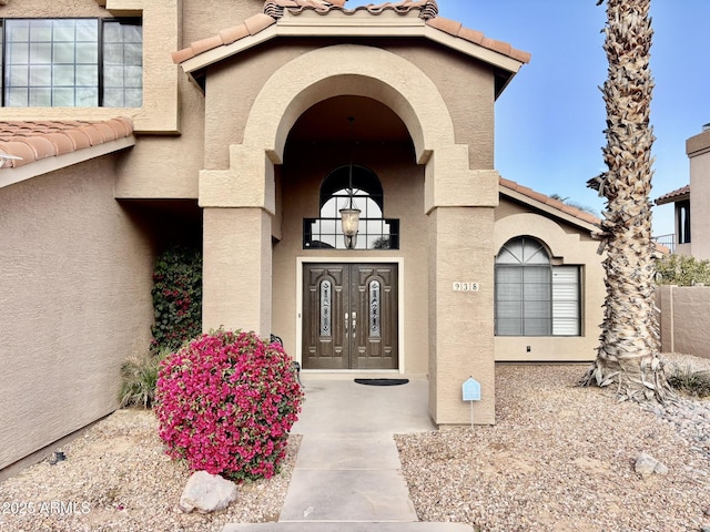 property entrance with a balcony and french doors