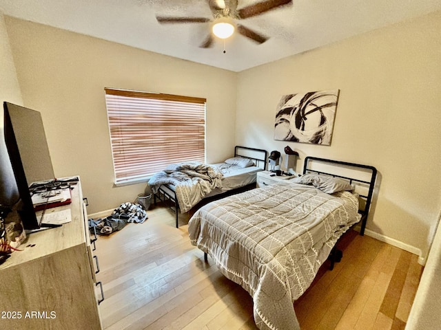 bedroom featuring ceiling fan and light wood-type flooring