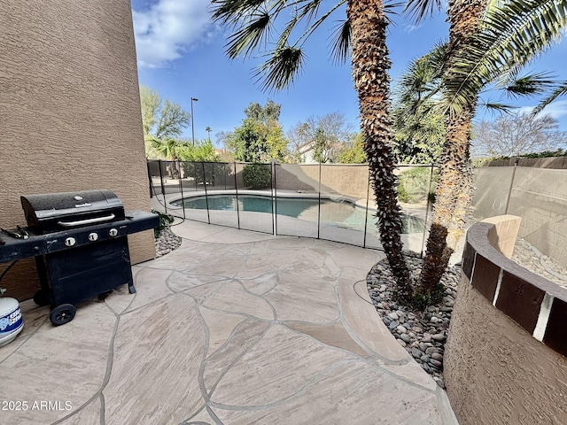 view of patio / terrace featuring a fenced in pool and grilling area