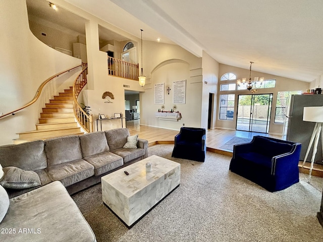 carpeted living room featuring a notable chandelier and a towering ceiling