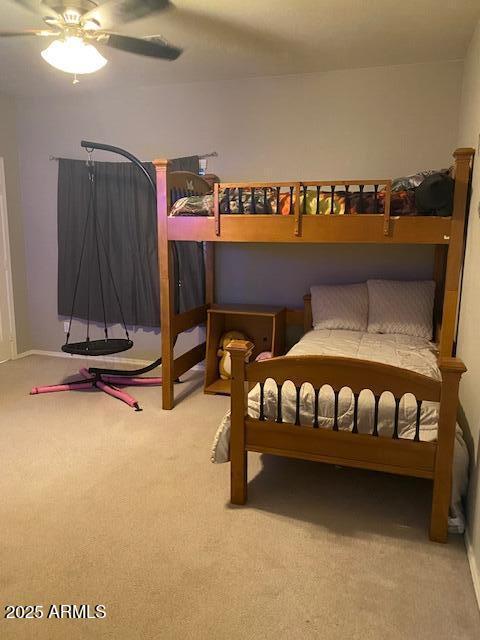 carpeted bedroom featuring ceiling fan