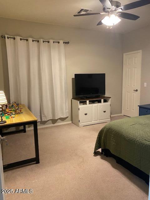 bedroom with ceiling fan, baseboards, visible vents, and light colored carpet