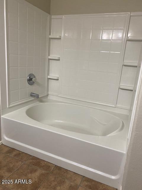 bathroom with tile patterned flooring and tub / shower combination