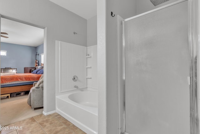 ensuite bathroom featuring a stall shower, tile patterned flooring, a tub, and connected bathroom