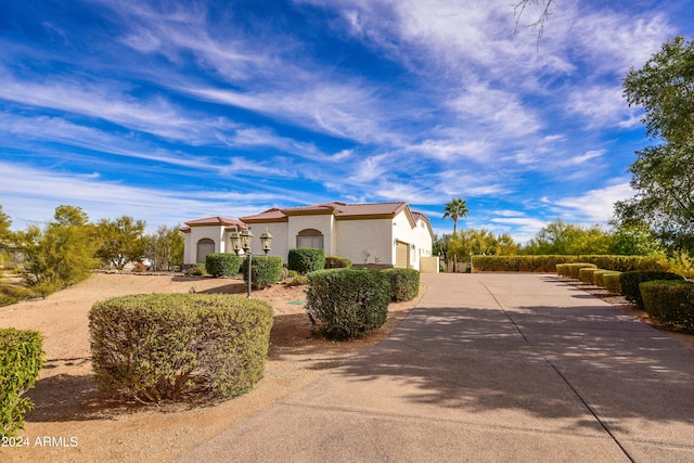 30009 N 58th St, Cave Creek, AZ 85331 - mediterranean / spanish-style house featuring a tile roof, a garage, stucco siding, and driveway