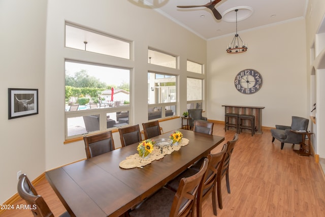 dining area featuring light hardwood / wood-style floors, ornamental molding, and ceiling fan