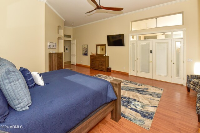 bedroom featuring ornamental molding, ceiling fan, and hardwood / wood-style floors