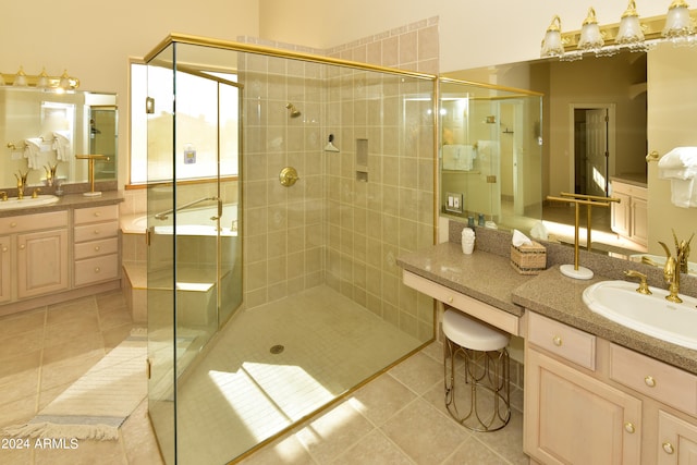 bathroom with tile patterned floors, a shower with door, and vanity