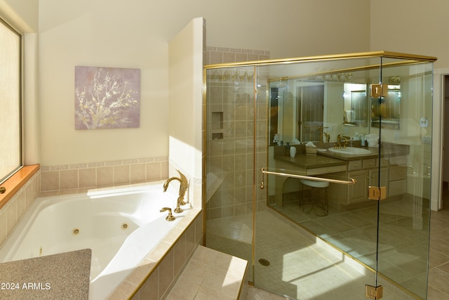 bathroom with independent shower and bath, vanity, and tile patterned floors