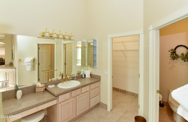 bathroom featuring vanity, a high ceiling, and tile patterned flooring