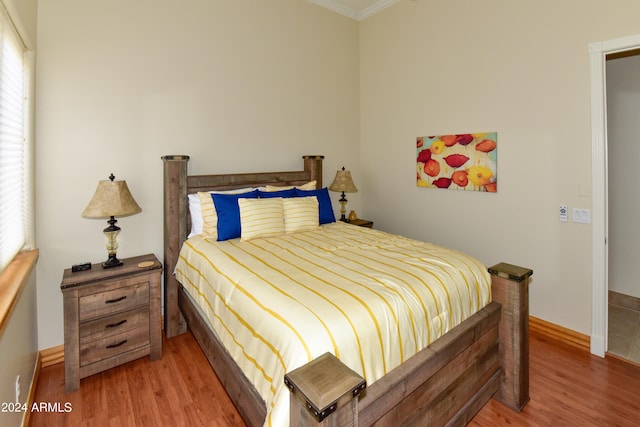 bedroom featuring crown molding and hardwood / wood-style floors