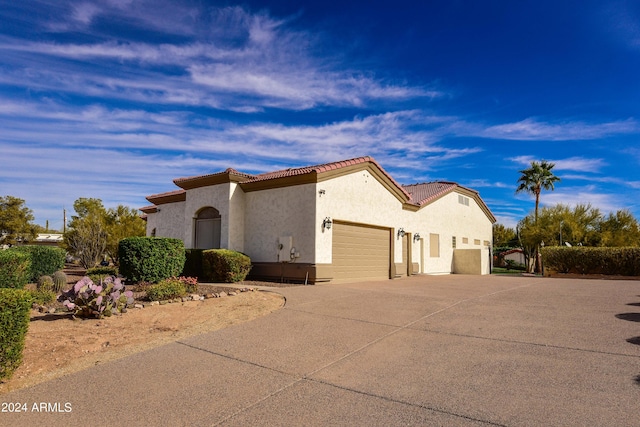 mediterranean / spanish house featuring a garage