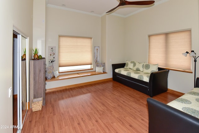 bedroom with ceiling fan, wood-type flooring, and ornamental molding