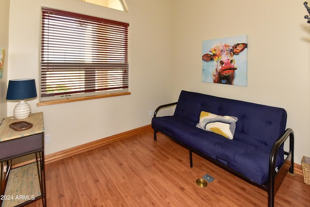 living area with a wealth of natural light and hardwood / wood-style flooring