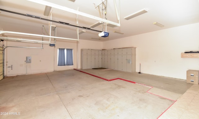 garage featuring a garage door opener and electric panel