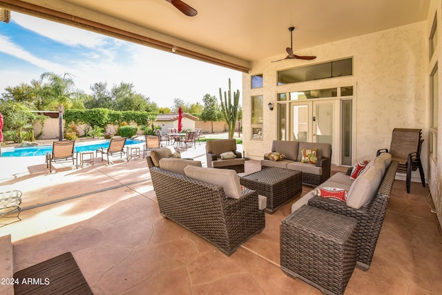 view of patio / terrace with an outdoor living space, a fenced in pool, and ceiling fan