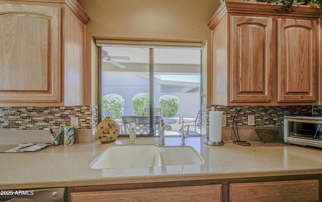 kitchen featuring decorative backsplash, a sink, light countertops, and dishwasher