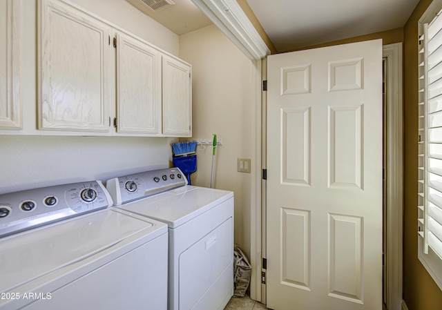 laundry room with cabinet space, washer and dryer, and light tile patterned floors