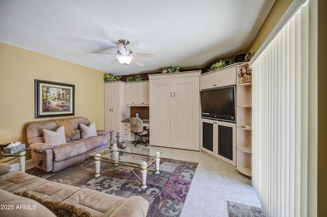 living area with ceiling fan, light tile patterned floors, and an office area