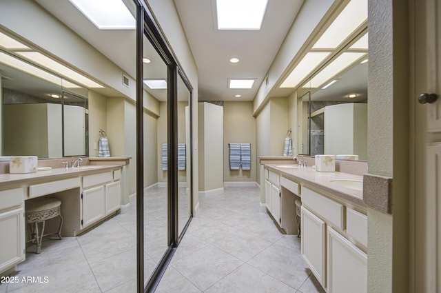 bathroom with double vanity, a stall shower, tile patterned flooring, and recessed lighting