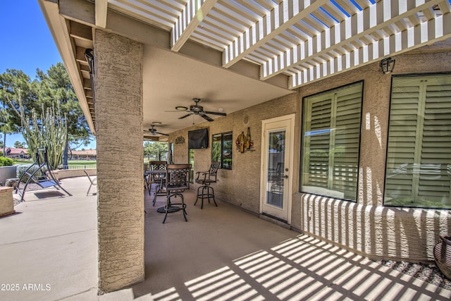 view of patio featuring a ceiling fan, a pergola, and outdoor dining area