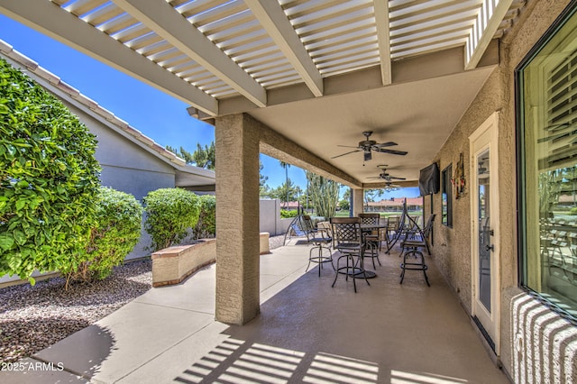 view of patio with outdoor dining area, ceiling fan, and a fenced backyard