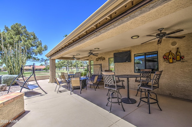view of patio / terrace with outdoor dining area and a ceiling fan