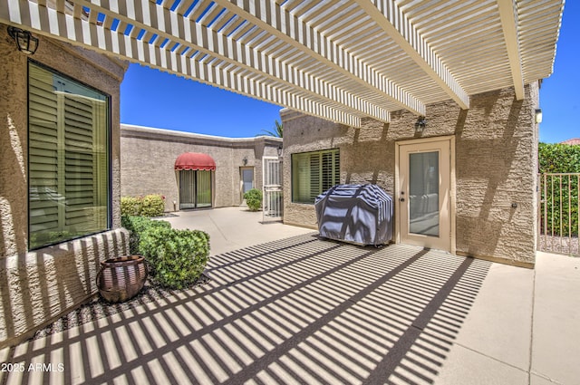 view of patio with a pergola and area for grilling