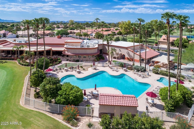 community pool featuring fence, a patio area, golf course view, and a residential view