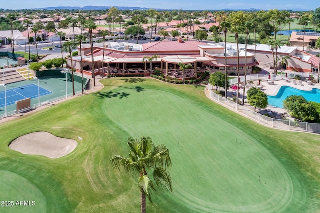 aerial view of a local golf course, a pool, and mountains