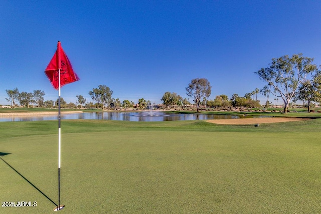 view of community with a water view and golf course view