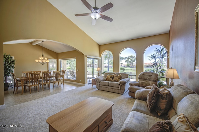 living area featuring light colored carpet, arched walkways, a chandelier, ceiling fan, and baseboards