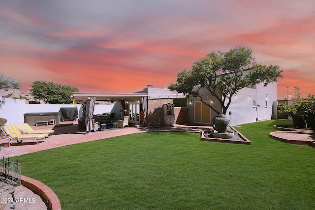 view of yard featuring a patio area, a hot tub, fence, and an outdoor living space