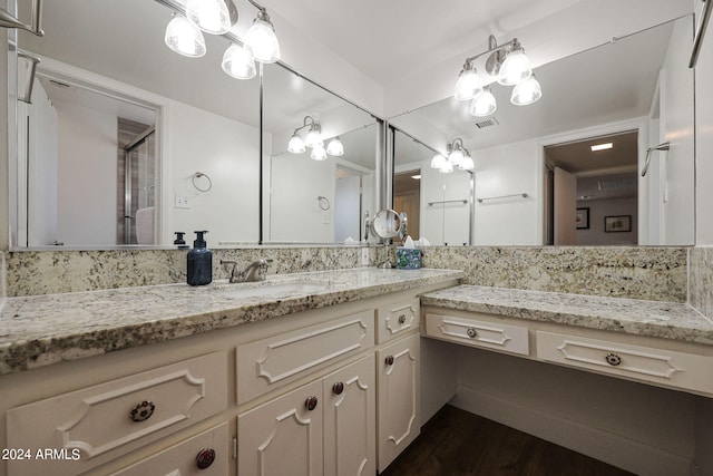 bathroom featuring hardwood / wood-style flooring, a shower with door, and vanity