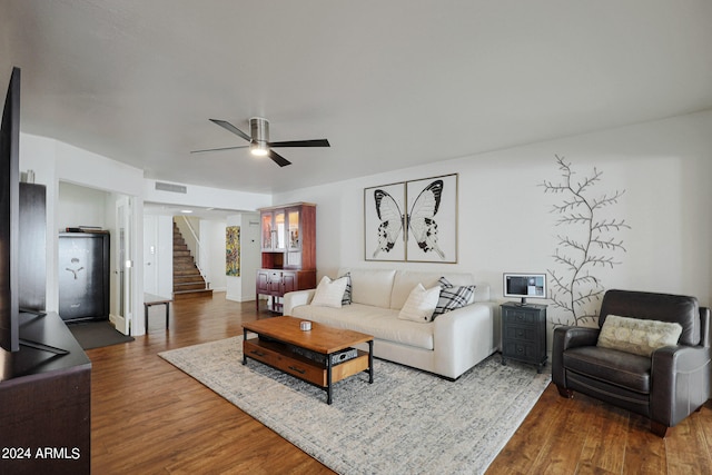 living room featuring ceiling fan and hardwood / wood-style floors