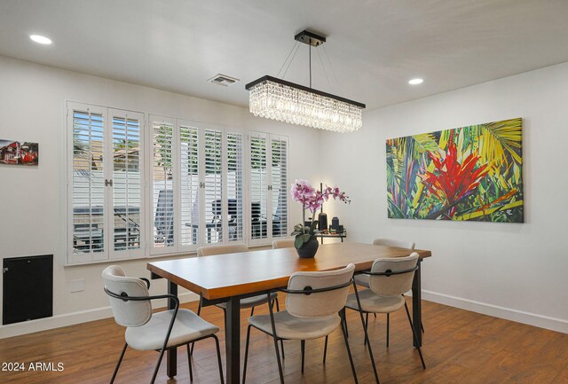 living room with ceiling fan, dark wood-type flooring, brick wall, french doors, and a fireplace