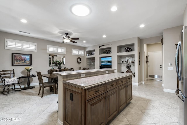 kitchen with visible vents, a kitchen island, baseboards, recessed lighting, and a ceiling fan
