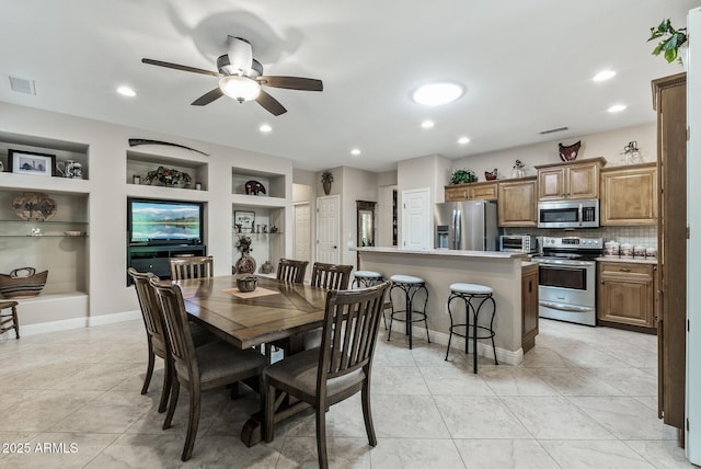 dining space featuring visible vents, ceiling fan, light tile patterned flooring, and built in shelves