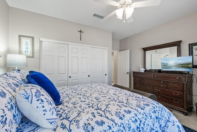 tiled bedroom with a closet, ceiling fan, and visible vents