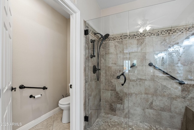 bathroom featuring toilet, a ceiling fan, baseboards, and a stall shower
