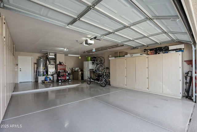 garage featuring white fridge with ice dispenser, a garage door opener, and water heater