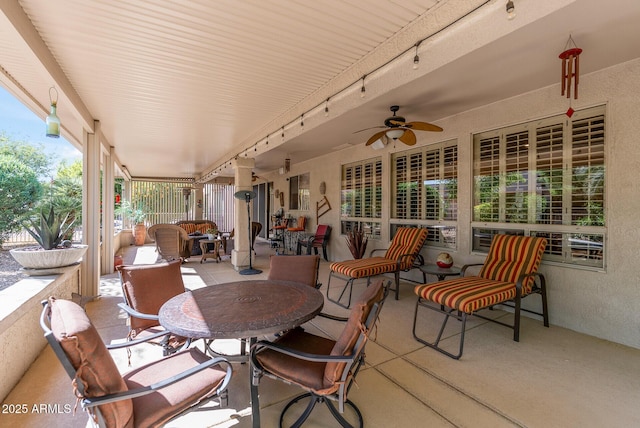 view of patio with outdoor dining area and ceiling fan
