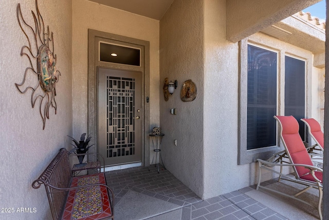 property entrance featuring stucco siding